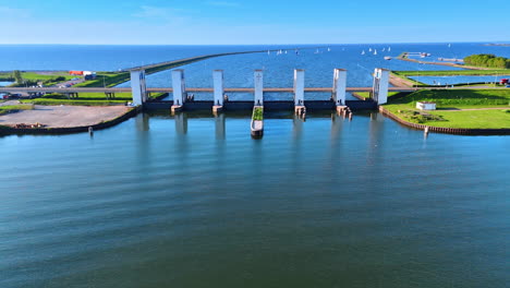 distancing from the houtrib sluices near lelystad, the netherlands. white sails on the blue waterscape at backdrop. aerial view.
