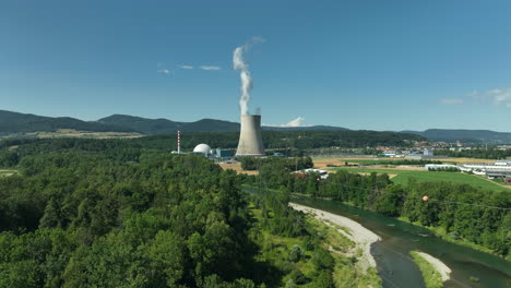 drone following high power line with nuclear power plant gösgen in background