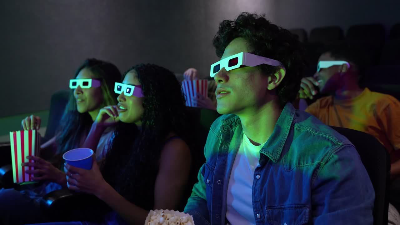 Friends Enjoying a Movie at the Cinema with 3D Glasses