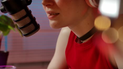 woman speaking into a microphone podcasting or live streaming