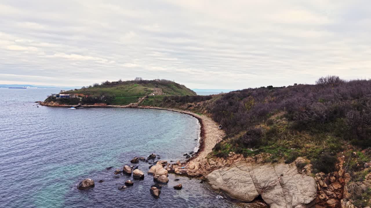 Scenic aerial view of rocky coastline and tranquil waters at sunset