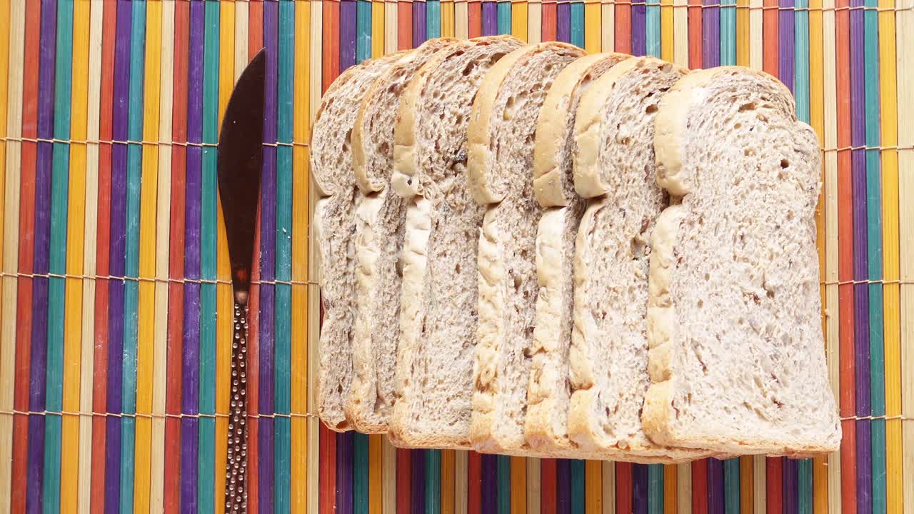 нарезанный цельнозерновый хлеб на красочной коврике