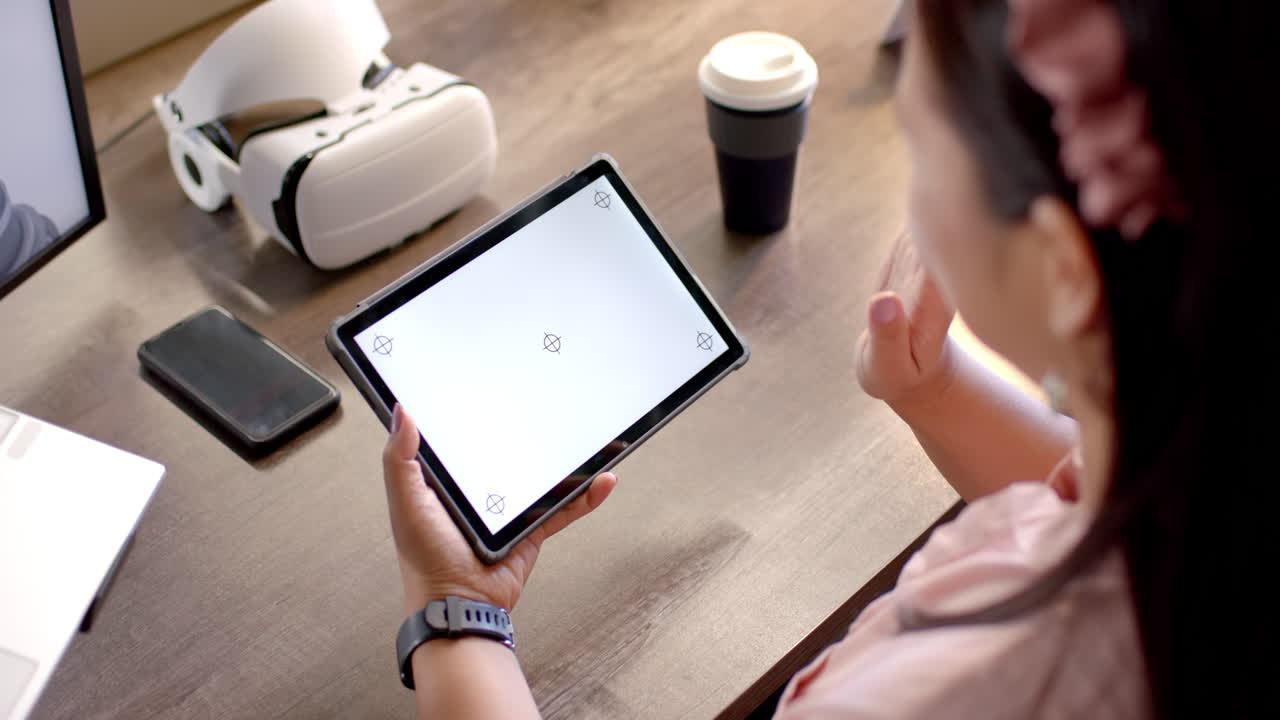 Using tablet, woman interacting with digital content in modern office setting, copy space