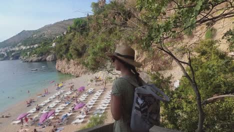 beautiful female model walking down the streets of dubrovnik to the beach