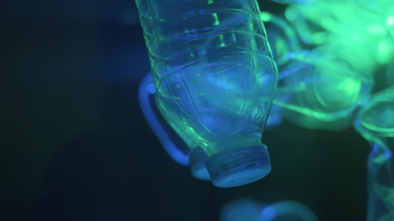 Bottle falling down loop of slow motion in background.Video 4K Resolutions.