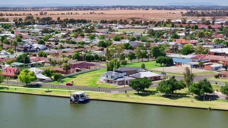 aerial view over a tourist boat moored on the shore of lake mulwala