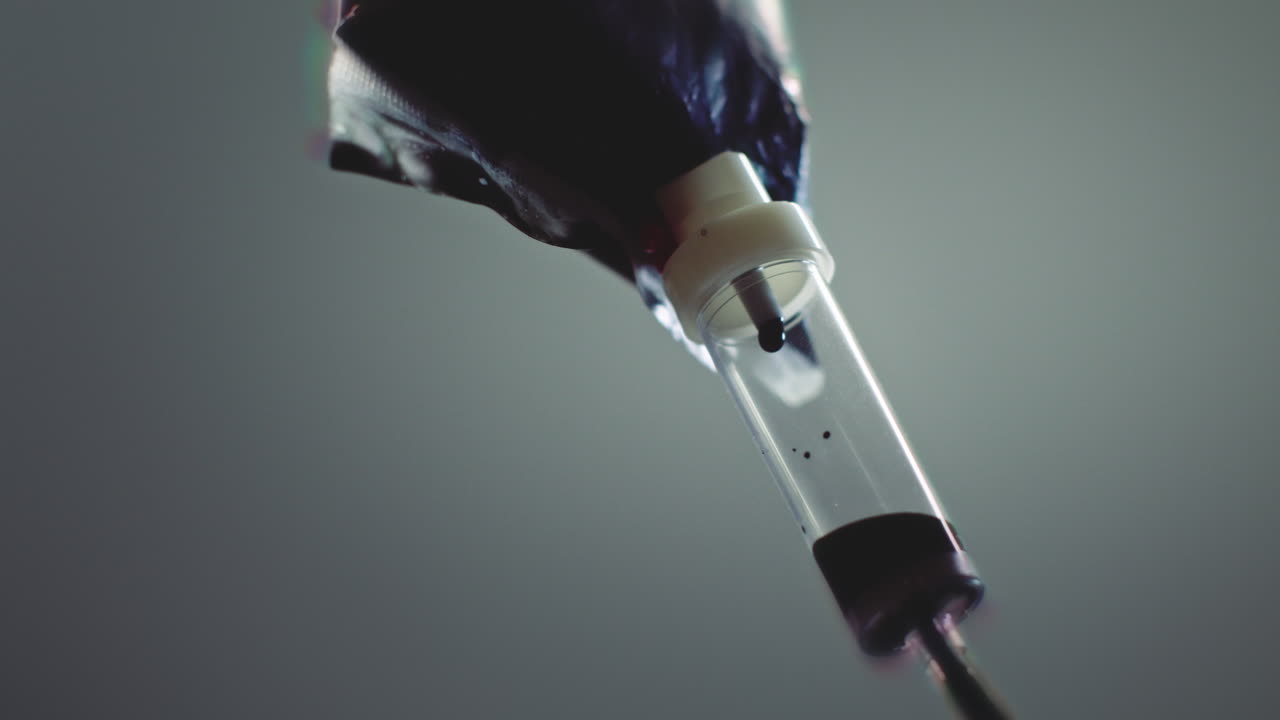 Dark liquid is dripping slowly