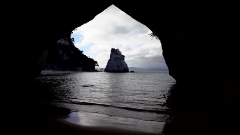 standing inside cathedral cove on coromandel peninsula