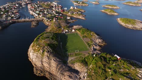 establishing drone shot above henningsvaer football stadium. lofoten islands, norway. summer