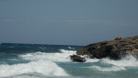 powerful waves from the ocean crashing on rocks and stones on the coast