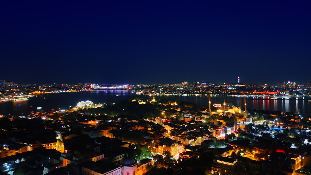 Night cityscape of modern luminous Istanbul. Capital of Turkey and Bosporus from aerial perspective
