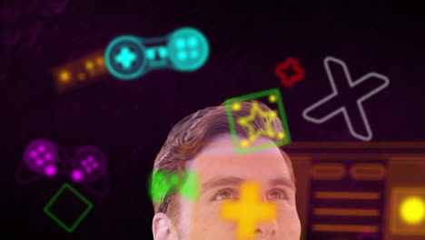 animación de iconos de juegos de neón sobre el hombre caucásico mirando hacia arriba