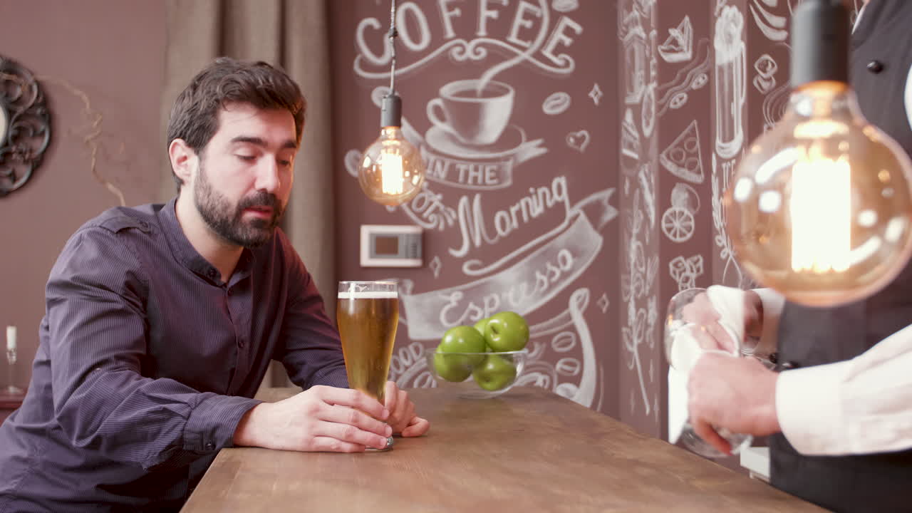 A man having a drink at a bar