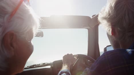 Senior-couple-driving-a-car-at-the-beach