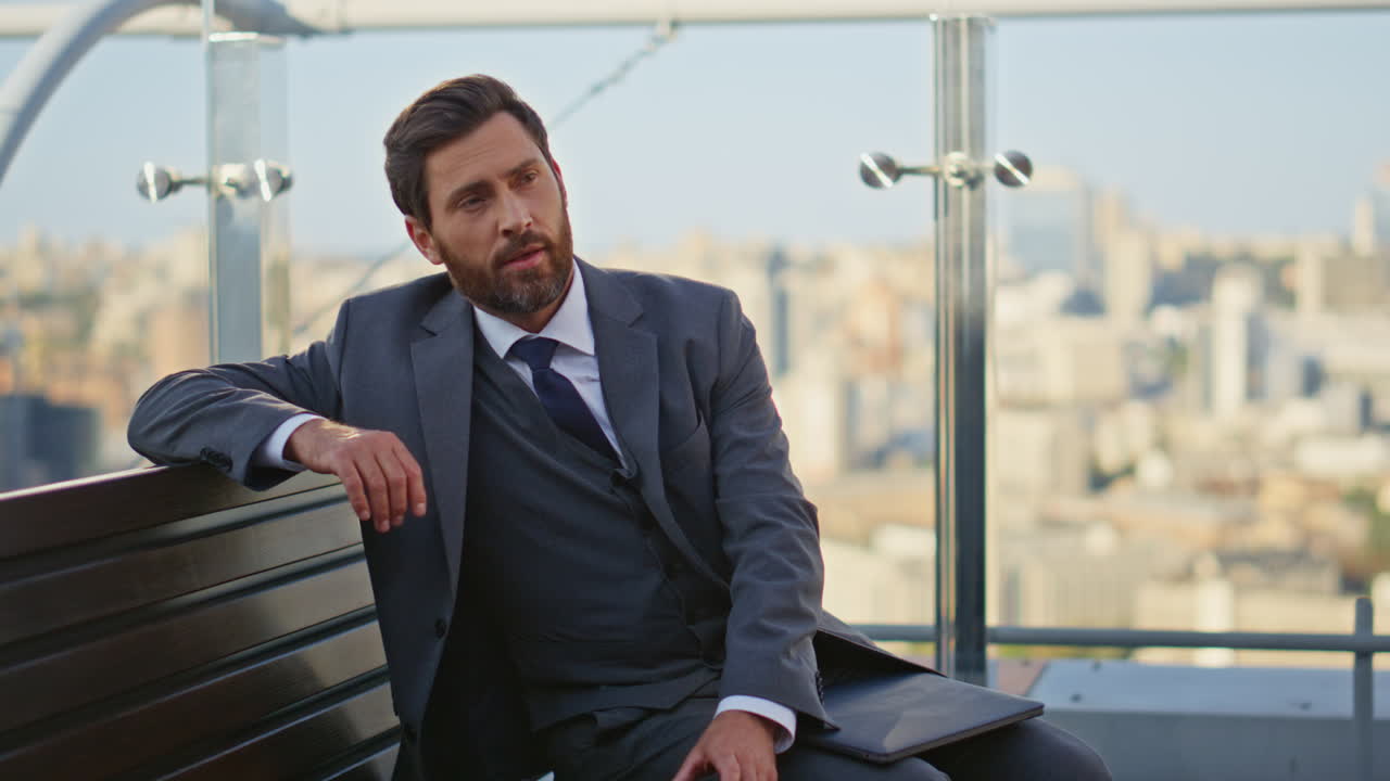 Remote businessman typing laptop on city terrace. Relaxed man finish work drink