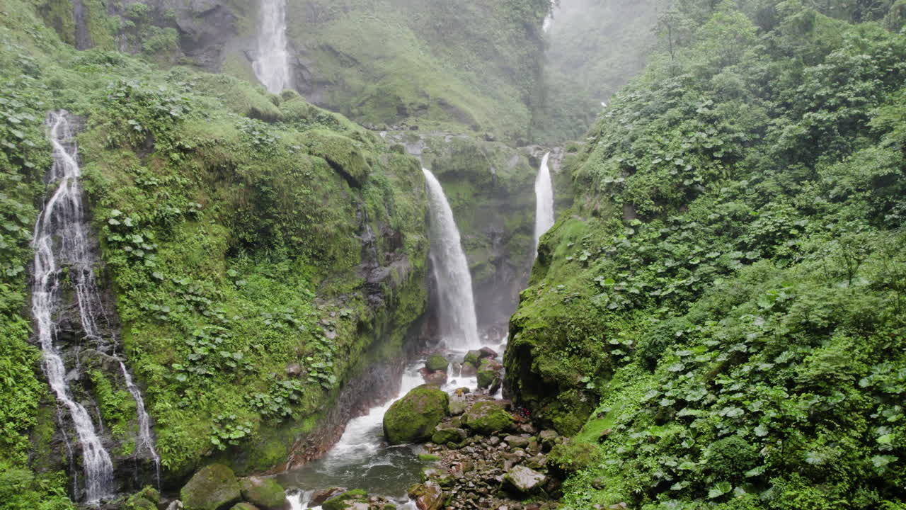 Aerial shot of idyllic nature scene as a few falls plunge into jungle ravine