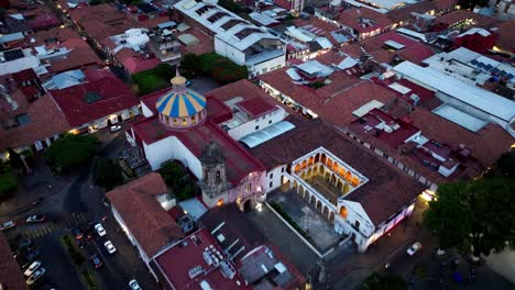 aerial night view of a colonial cityscape with a domed church
