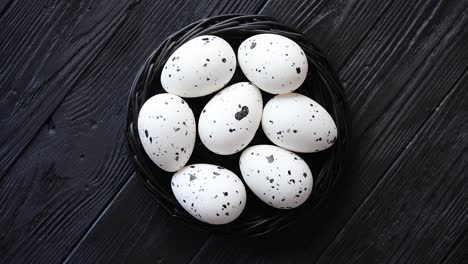 Whole-Chicken-eggs-in-a-nest-on-a-black-rustic-wooden-background--Pascua-symbols