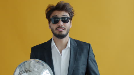 man in suit with disco ball