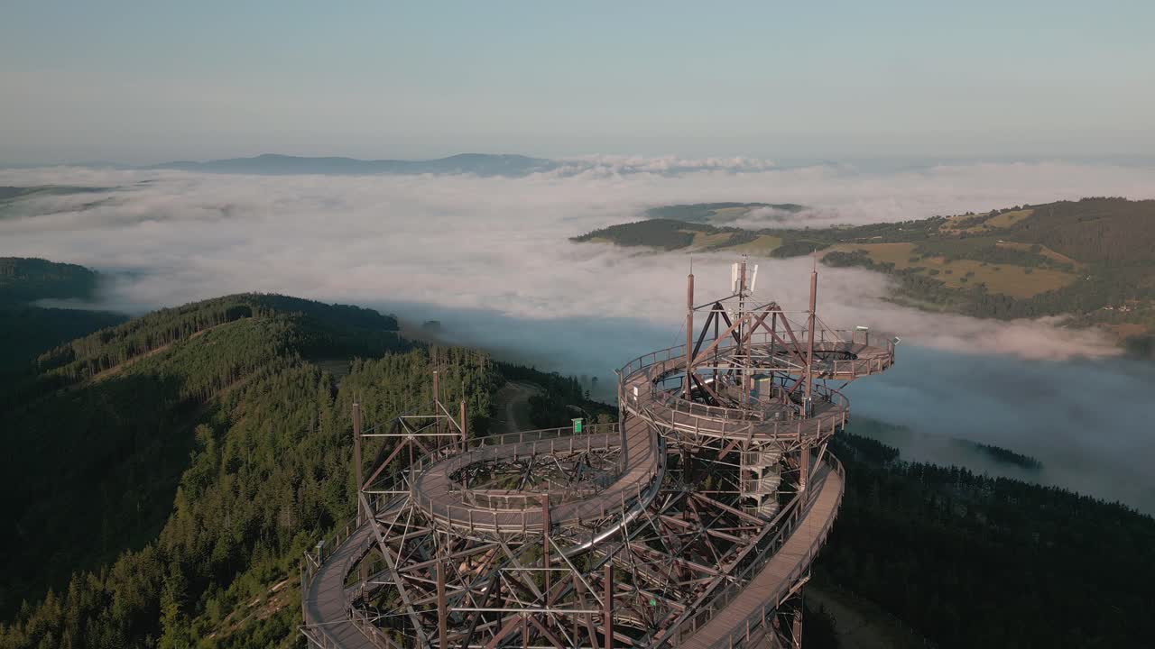 he massive wooden structure of the path in the clouds towering over the misty valley