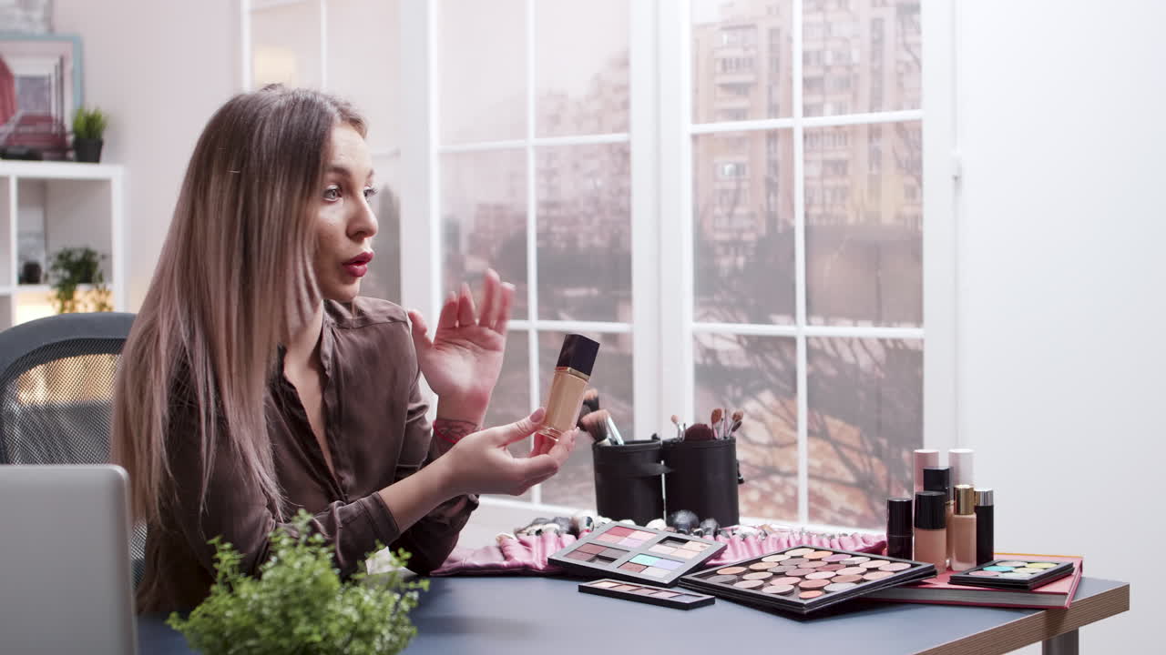 Woman vlogging about makeup at her desk