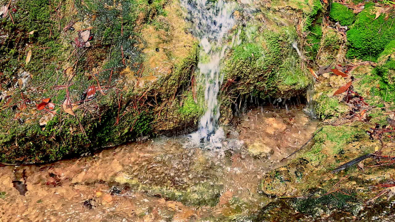 Mountain waterfalls with rocky slopes. Crystal clear water flows over rocks in the mountains. Mountain rivers