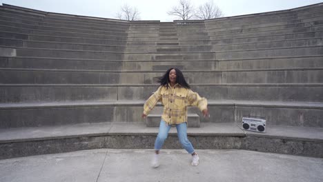 black woman listening to music and dancing