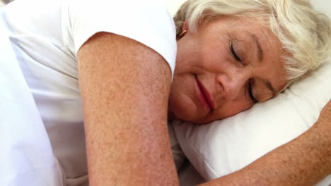 senior woman sleeping in her bed