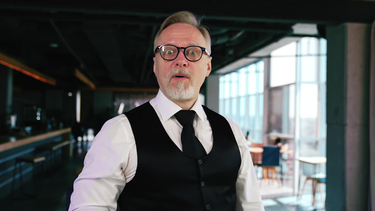 Old man puts on glasses and reacts with surprise on the difference in sight. Adult guy puts off glasses and sees badly.