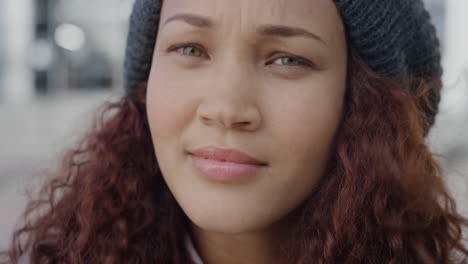 Primer-Plano-Retrato-Hermosa-Joven-Mujer-De-Raza-Mixta-Gira-La-Cabeza-Mirando-Confiada-Calma-Mujer-Independiente-Con-Gorro-Viento-Soplando-Pelo-Cámara-Lenta