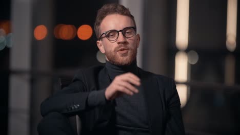 portrait of stylish young man in business suit talking looking at camera