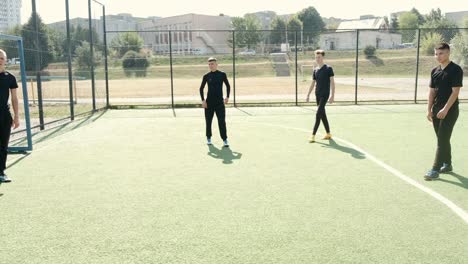 young soccer players training football on the pitch