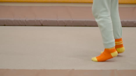 Legs-Closeup-of-Toddler-Jumping-on-Indoor-Trampoline