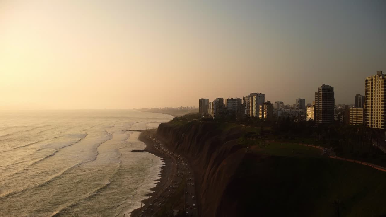 Aerial drone view of the traffic on Circuito de Playas road and the coastline of Miraflores, Lima, Peru