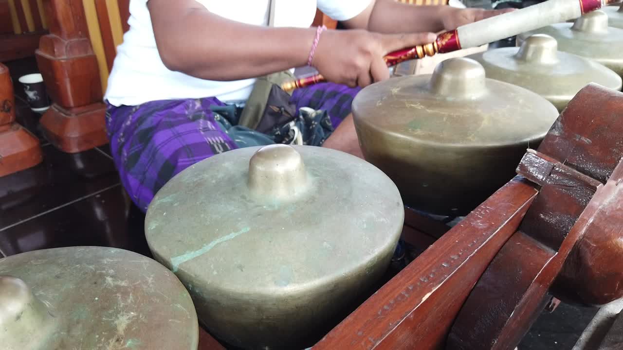 Gamelan Musician Plays Traditional Instruments of Percussion Bali Indonesia in Wedding Ceremony, Golden Bronze Bells