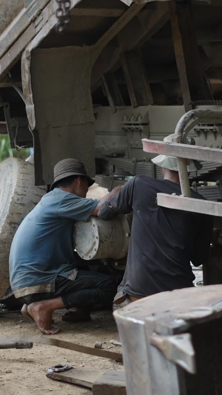 Men Repairing a Truck