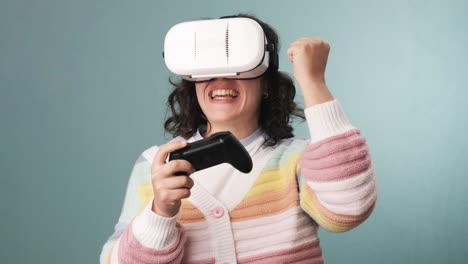 slow motion video of a woman having fun while playing video games with vr glasses and a joystick.