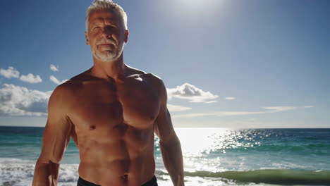 muscular mature man on a sunny beach