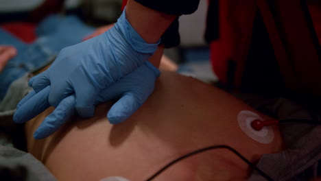 unrecognizable paramedic doing cpr to unconscious man