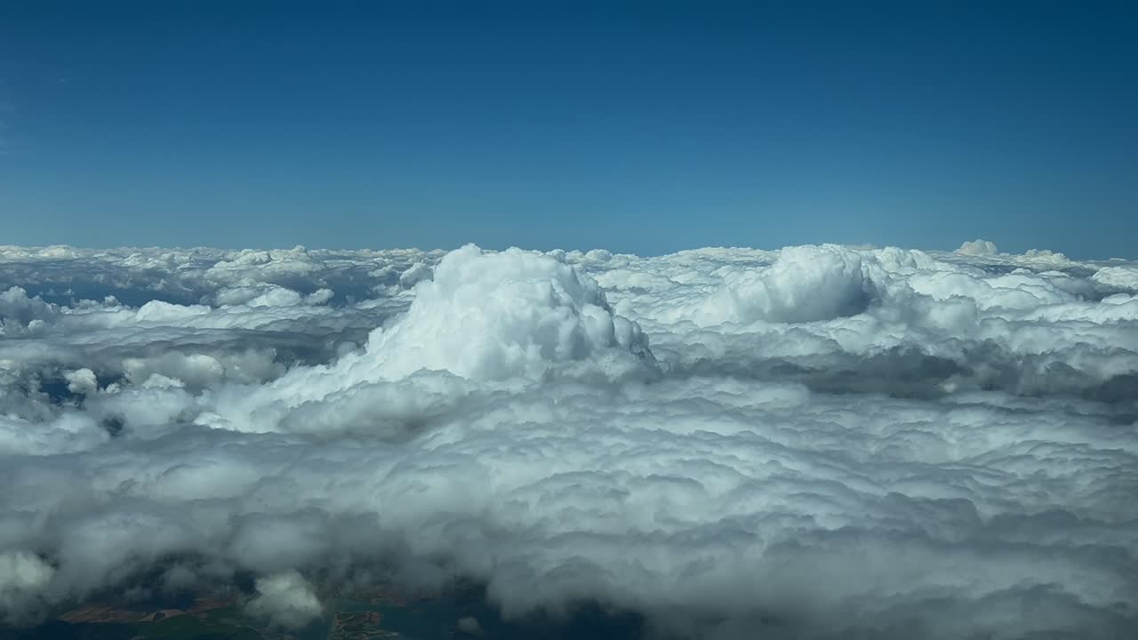 POV flying above some stormy clouds, as seen by the pilots of a jet