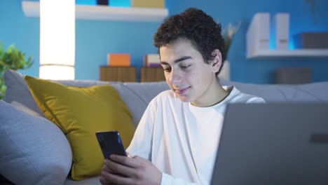 Happy-and-cheerful-boy-using-social-media-on-his-smartphone,-hanging-out-in-virtual-world.