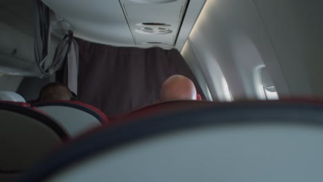 back view of passengers sitting inside airline cabin during flight - airbus a319