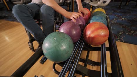 two young disabled men in wheelchairs playing bowling in the club