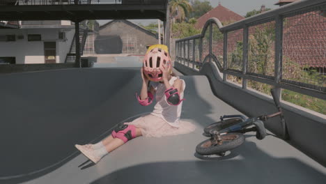 chica divirtiéndose mientras descansa después de montar una bicicleta