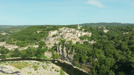 aerial approach to balazuc village on cliff next ardèche river