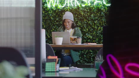 happy business woman using video chat on laptop computer waving hand enjoying online communication talking sharing lifestyle relaxing on lunch break in trendy modern office