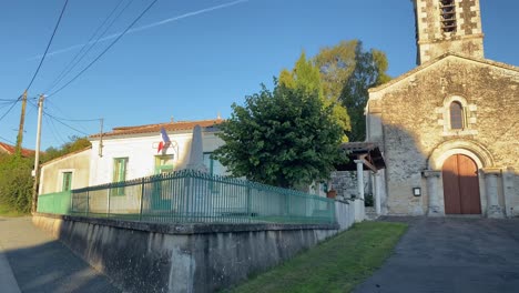 French-mayor’s-office-and-church-in-evening-sunlight