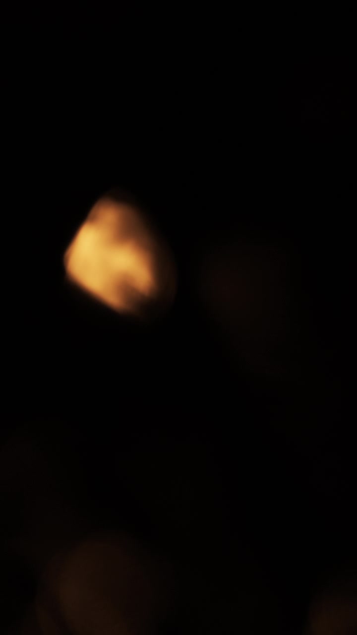 Abstract Golden Light Bokeh Effect on Dark Background