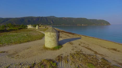 aerial over beautiful windmills reveals greek island of lefkada