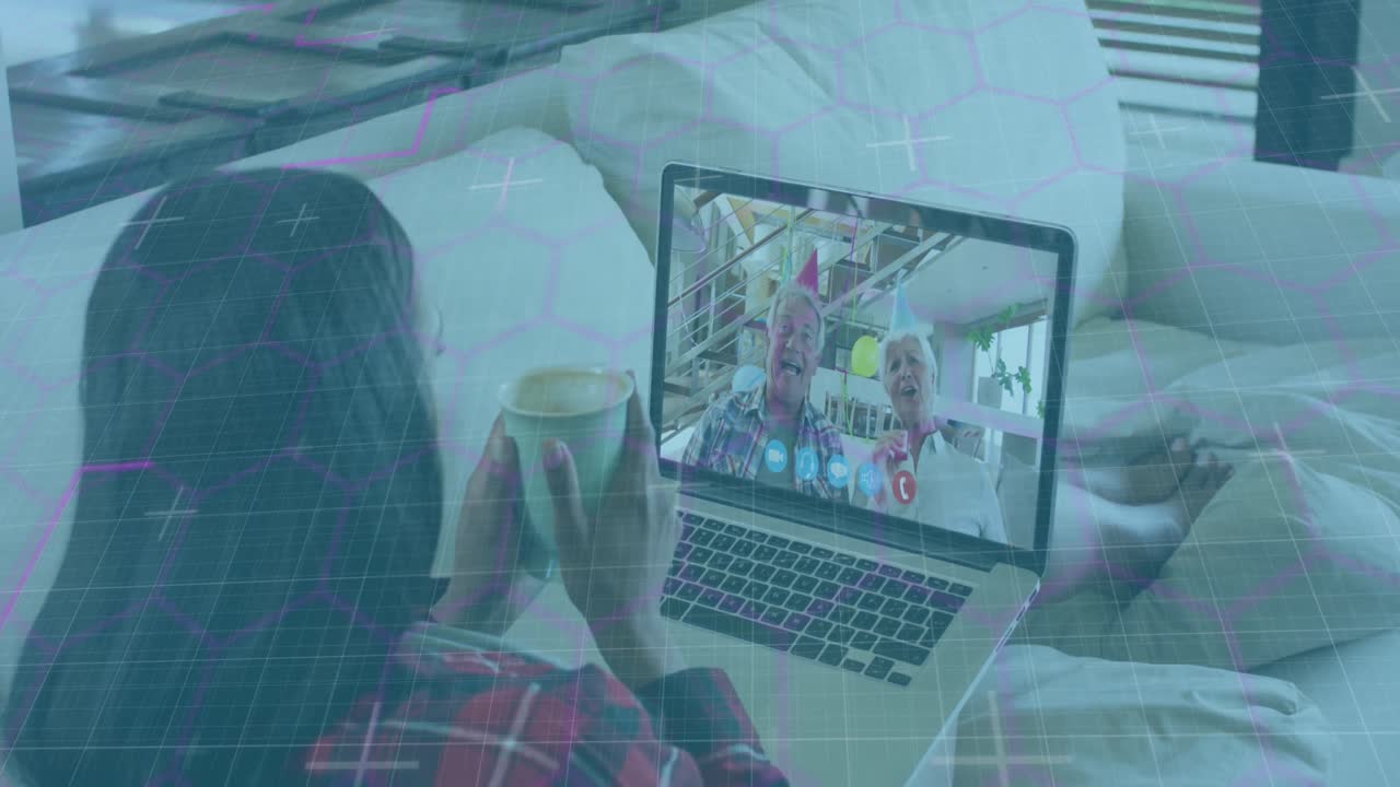 Animation of network of hexagons over woman using laptop on video call in background